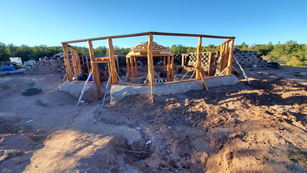 A wooden structure outdoors that seems to be designed to hold up a ceiling. 